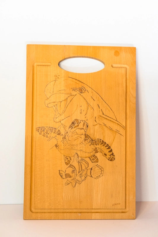 Beach wood cutting board, wood-burnt with sea creatures.