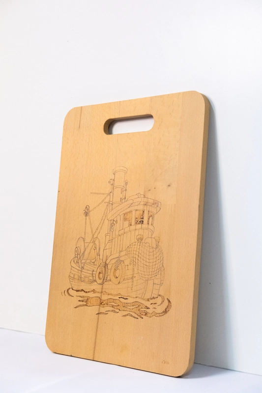 Beachwood chopping board, woodburnt with picture of New York Tug boat.  14” x 9” 36cm x 23cm