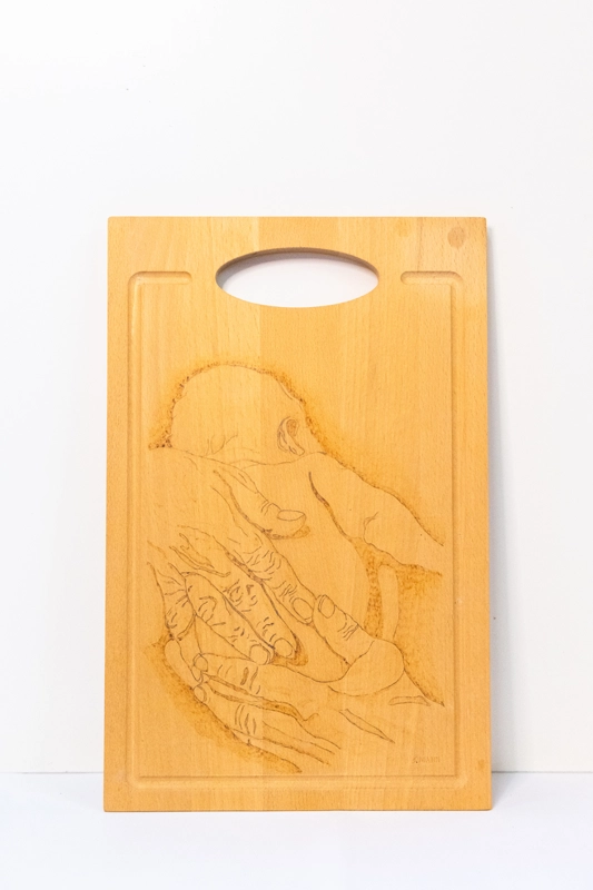 Beachwood chopping board woodburnt with picture of a new born held in old hands.  14” x 9”. 36cm x 23cm