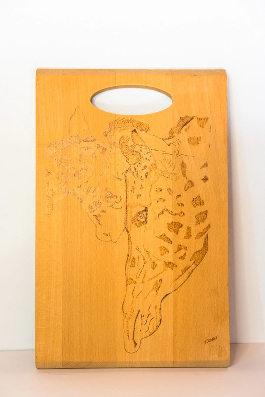 A beach wood chopping board, wood-burnt with design of mother and calf giraffes,