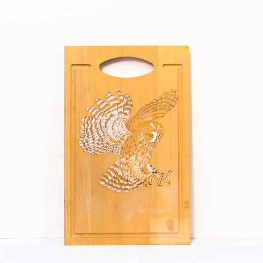 Beachwood chopping board woodburnt with a picture of an Owl landing, finished using acrylic.  14” x 9”. 36cm x 23cm