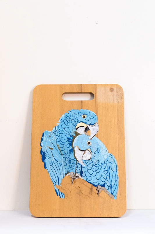 Beach wood Chopping board decorated with picture of two embracing Blue Macaw parrots in acrylic.﻿﻿
