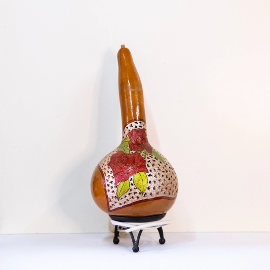 A gour lamp depicting red roses, woodburnt, carved and finished in wellburn inks. Mounted on a metal base. Mains powered. 40cm tall