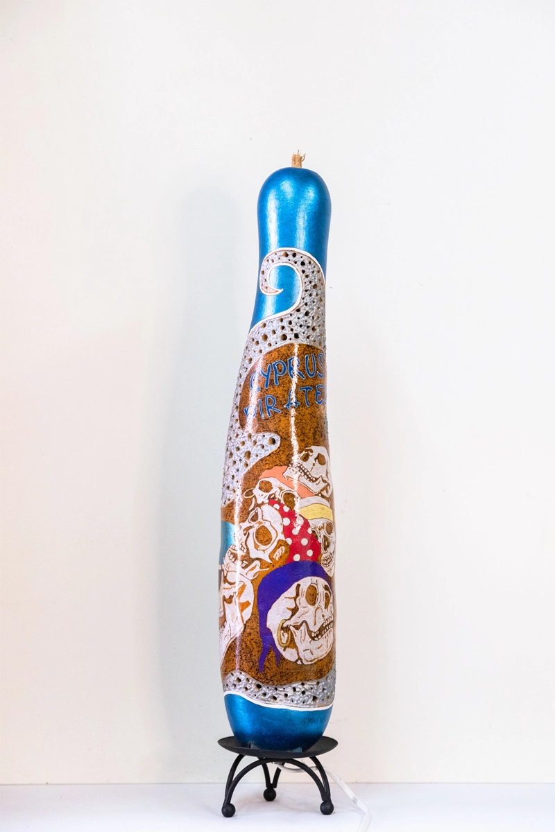 Tall bodied Gourd lamp decorated with Cyprus pirates. Wood-burnt, carved and finished in acrylics. Mains powered. 55cm..