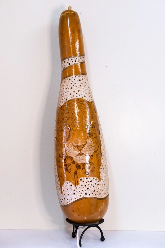 Tall Gourd lamp with Cheetah adornment. Wood-burnt, carved and finished in acrylic on a metal tripod base. Mains powered. 65cm tall.
