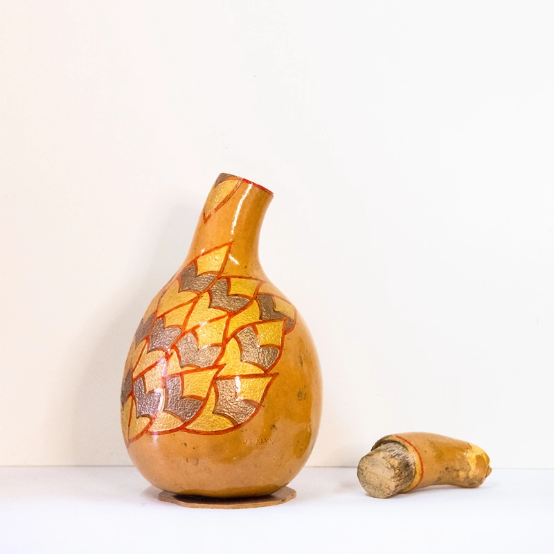 Gourd wine carafe. Wood-burnt, carved and finished in acrylics. 30cm tall.