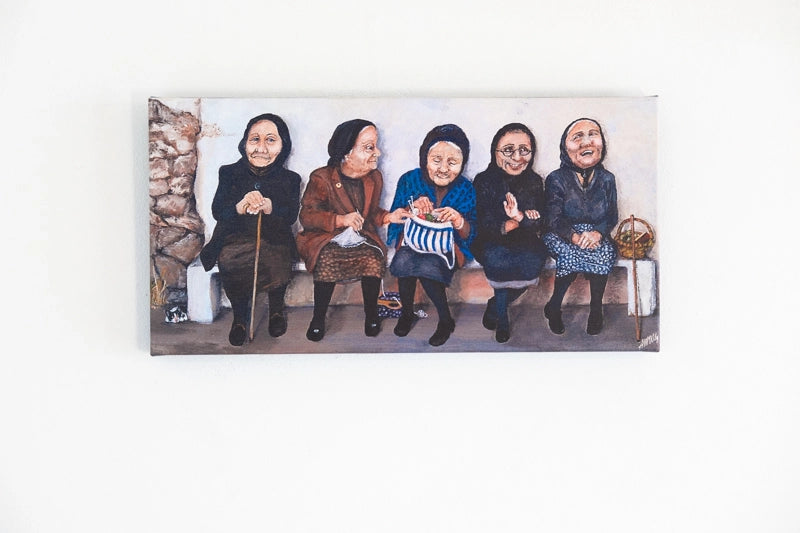Cypriot women seated and working on needlework whilst chatting 