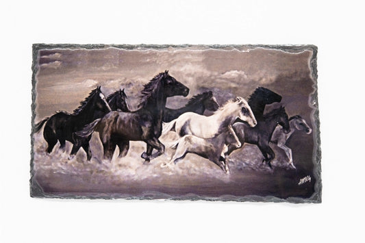 Wild horses galloping along the beach. Printed on slate